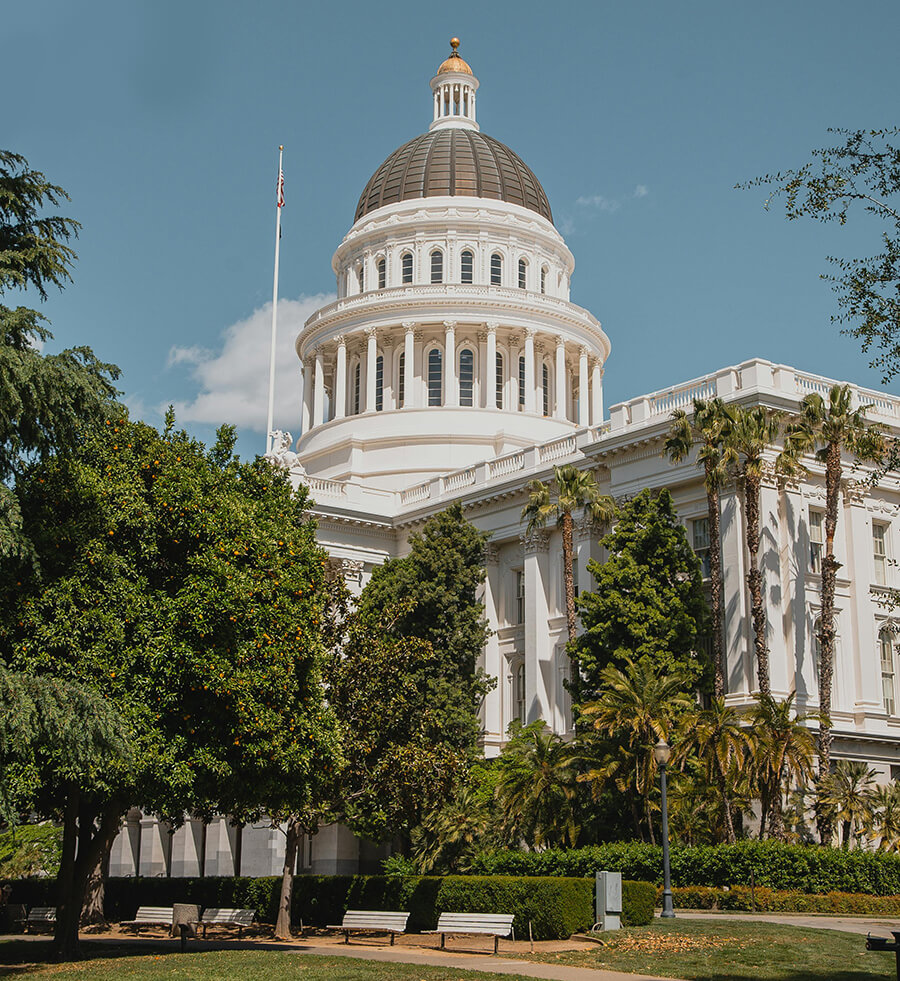 California Capitol building with surrounding greenery